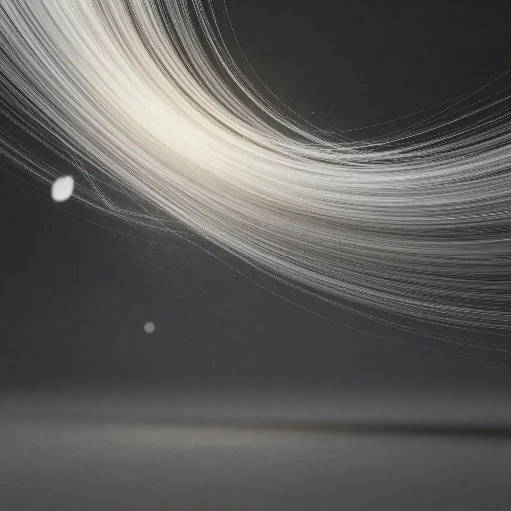 Silver filaments converge into a white bloom in a dark graphite void, with empty copy space.